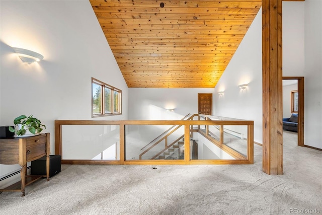 additional living space with wood ceiling, carpet, high vaulted ceiling, and baseboards