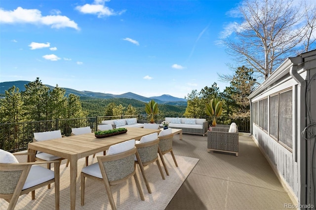 view of patio / terrace featuring an outdoor hangout area, outdoor dining area, and a mountain view