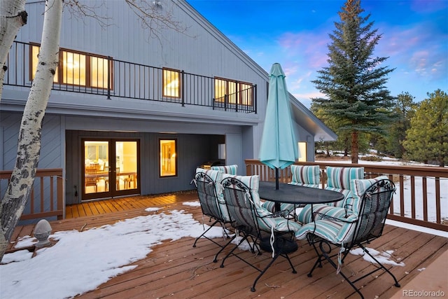 snow covered deck with outdoor dining area