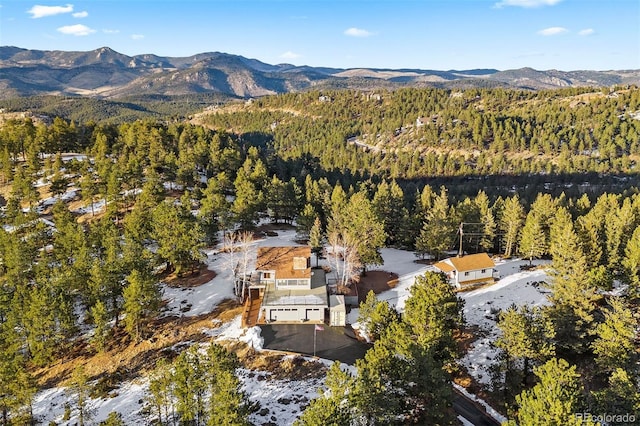 drone / aerial view featuring a forest view and a mountain view