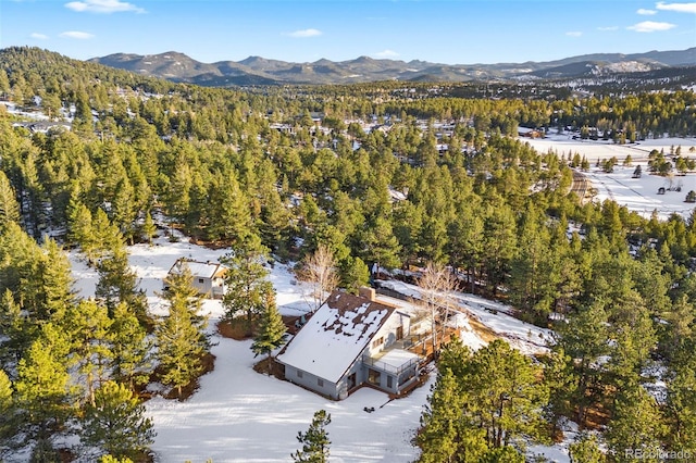 aerial view featuring a mountain view and a view of trees