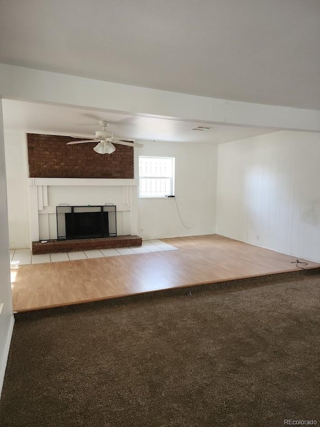 938 Salem St, Aurora, CO 80011 - unfurnished living room featuring carpet flooring, ceiling fan, and a fireplace with raised hearth