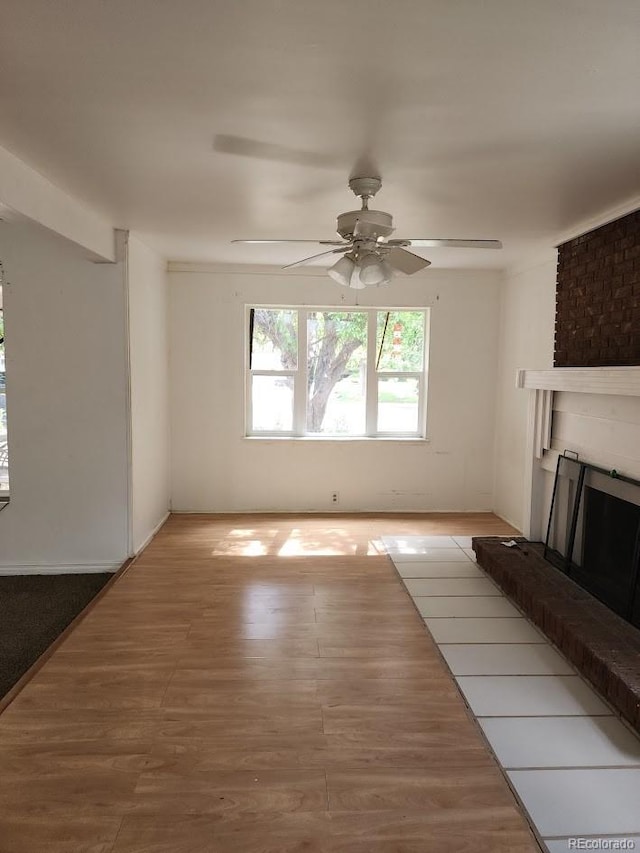 938 Salem St, Aurora, CO 80011 - unfurnished living room with wood finished floors, a fireplace, and a ceiling fan
