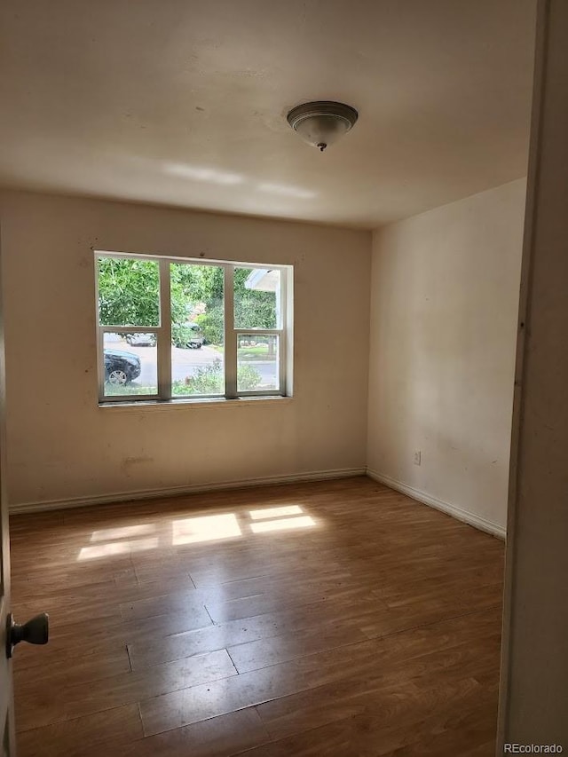 938 Salem St, Aurora, CO 80011 - unfurnished room featuring wood finished floors and baseboards