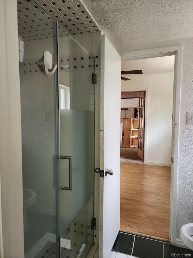 938 Salem St, Aurora, CO 80011 - full bathroom featuring a stall shower, wood finished floors, and a ceiling fan