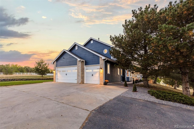 view of front of house with brick siding, driveway, and an attached garage