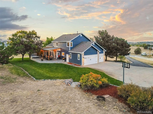 view of front of home with a garage, a front yard, and concrete driveway