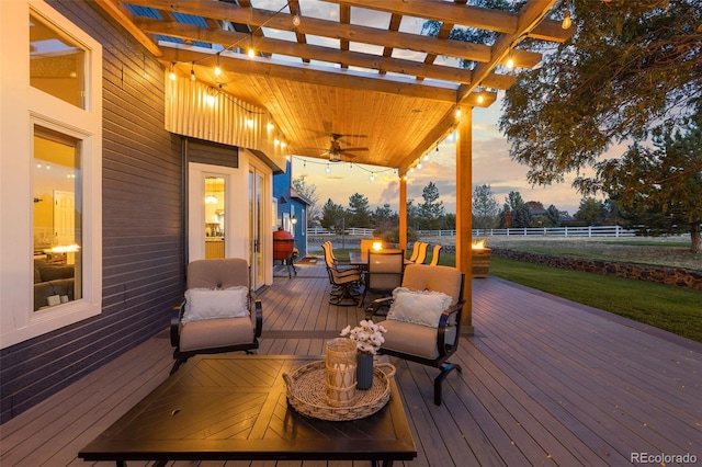 wooden deck featuring ceiling fan, outdoor dining space, fence, and a pergola