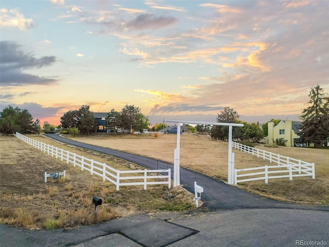 view of yard with a rural view and fence