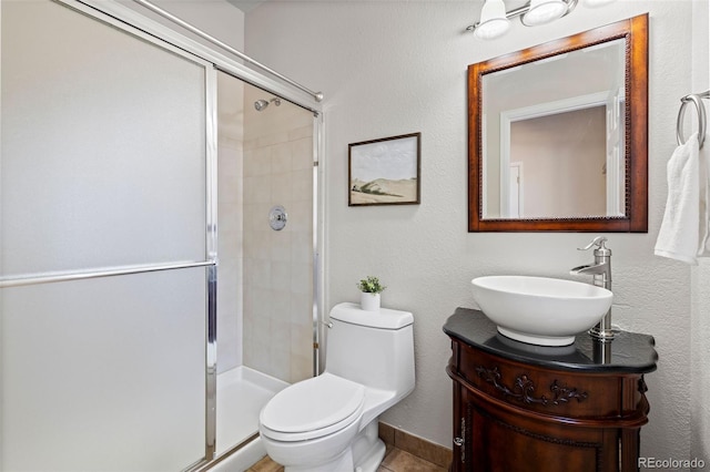 full bathroom featuring vanity, a shower stall, and toilet