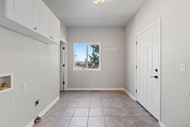 washroom with light tile patterned floors, hookup for a washing machine, cabinet space, hookup for an electric dryer, and baseboards