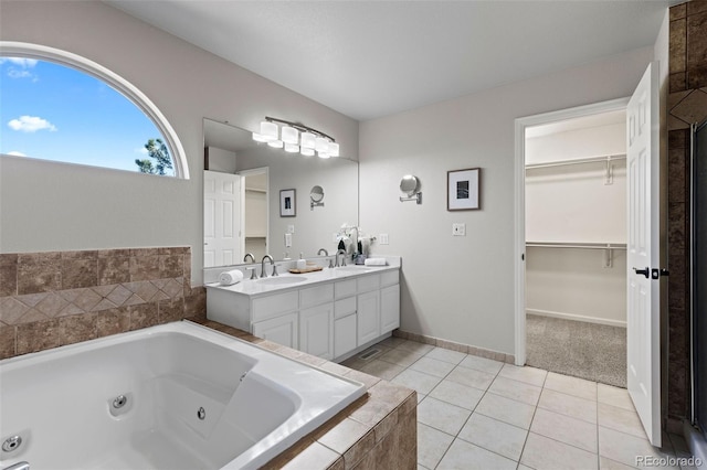 full bath featuring double vanity, tile patterned flooring, a tub with jets, and a sink