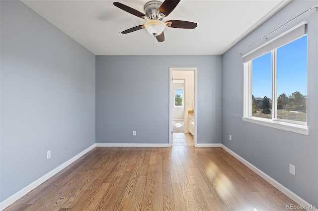 unfurnished room with ceiling fan, baseboards, and wood finished floors