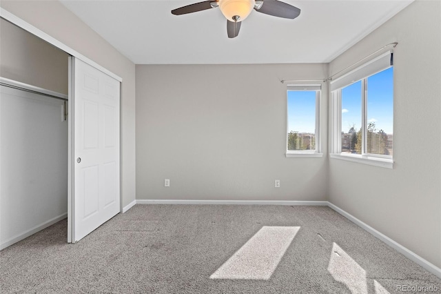 unfurnished bedroom with carpet floors, baseboards, and a closet