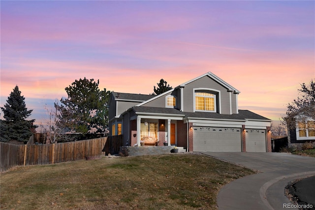 front of property with a garage and a yard