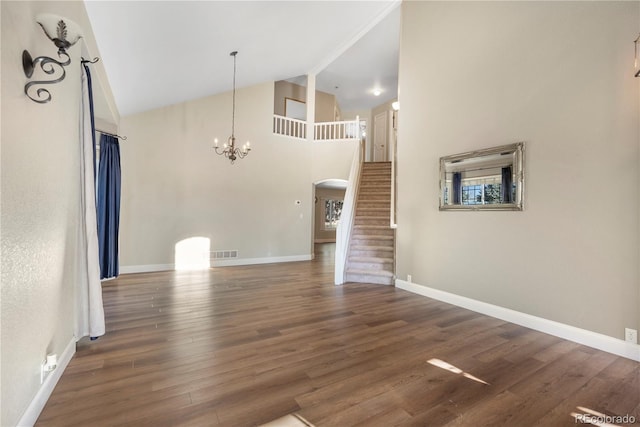 unfurnished living room with a chandelier, beam ceiling, dark hardwood / wood-style floors, and high vaulted ceiling