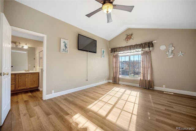 unfurnished room featuring light wood-type flooring, vaulted ceiling, and ceiling fan