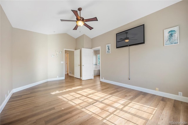 unfurnished bedroom with ceiling fan, hardwood / wood-style floors, and vaulted ceiling