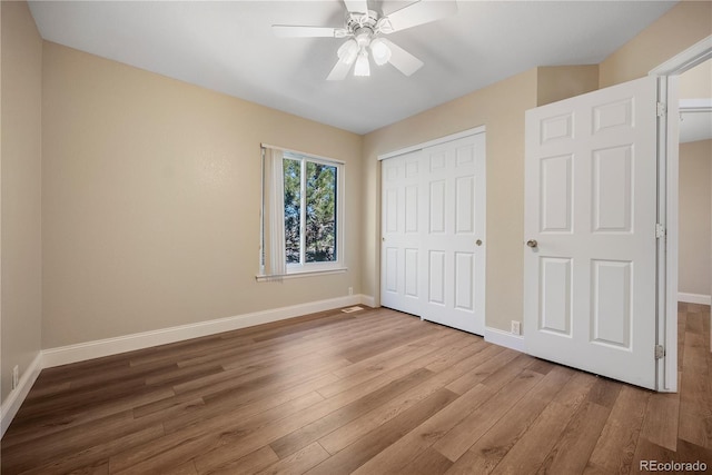 unfurnished bedroom featuring hardwood / wood-style flooring and ceiling fan