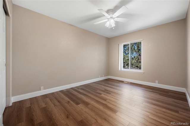 unfurnished room featuring ceiling fan and dark hardwood / wood-style flooring