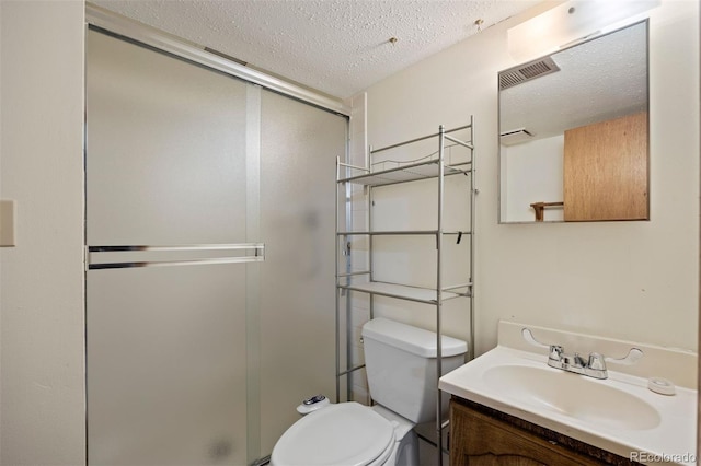 5808 E Hinsdale Pl, Centennial, CO 80112 - full bathroom featuring toilet, vanity, a stall shower, and a textured ceiling