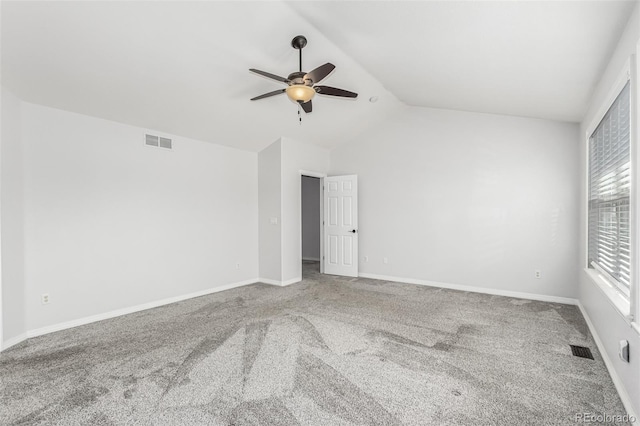 empty room featuring carpet floors, vaulted ceiling, and ceiling fan