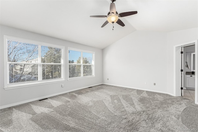 unfurnished room featuring vaulted ceiling, ceiling fan, and carpet floors