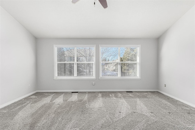 unfurnished room featuring ceiling fan, plenty of natural light, and carpet flooring