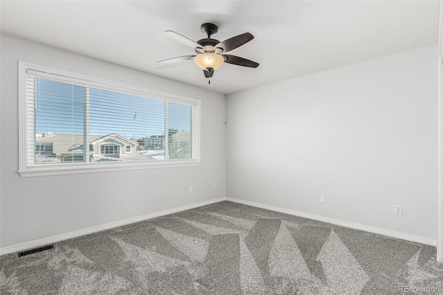 carpeted spare room featuring ceiling fan