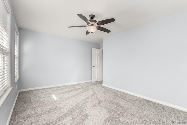 unfurnished room with carpet floors, a healthy amount of sunlight, and ceiling fan