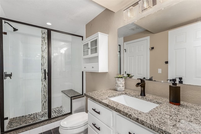 bathroom with vanity, toilet, and walk in shower