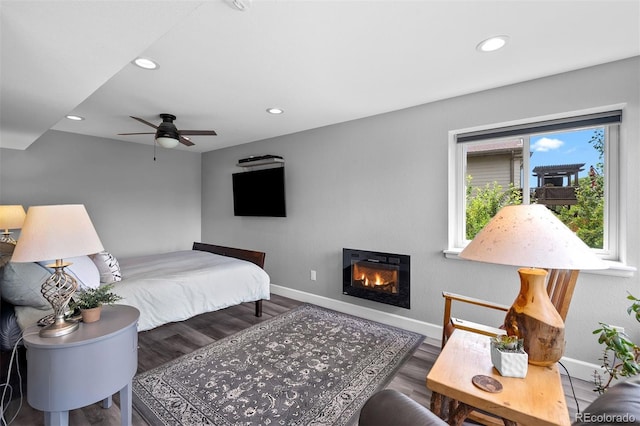 603 E 2nd Ave, Castle Rock, CO 80108 - bedroom with recessed lighting, a glass covered fireplace, wood finished floors, and ceiling fan