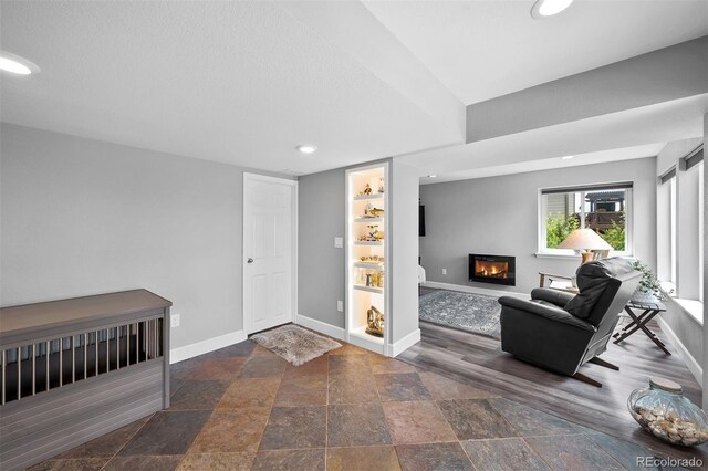 603 E 2nd Ave, Castle Rock, CO 80108 - foyer with a glass covered fireplace, recessed lighting, and stone tile floors