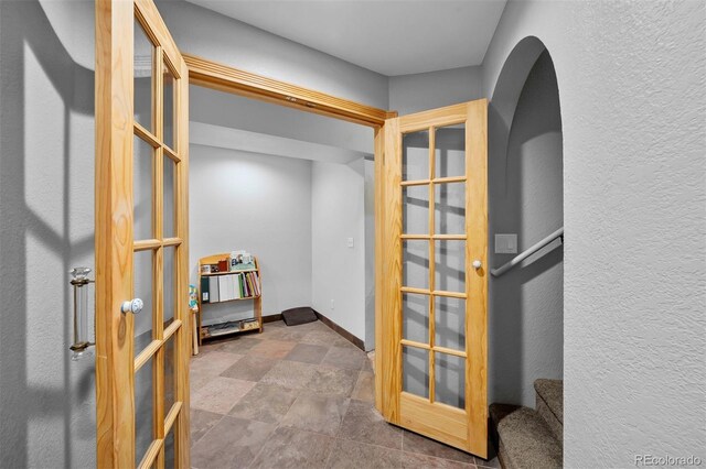 603 E 2nd Ave, Castle Rock, CO 80108 - hall featuring arched walkways, french doors, and stone finish flooring