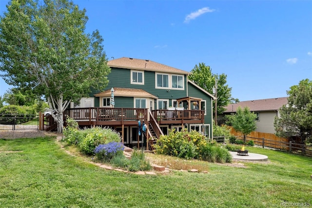 603 E 2nd Ave, Castle Rock, CO 80108 - back of property featuring a wooden deck, a fenced backyard, stairway, and an outdoor fire pit