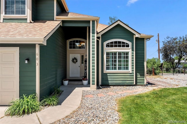 603 E 2nd Ave, Castle Rock, CO 80108 - view of exterior entry featuring a shingled roof and an attached garage