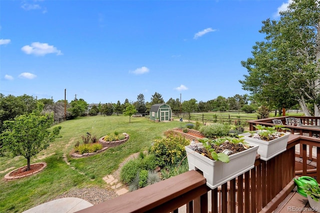 603 E 2nd Ave, Castle Rock, CO 80108 - fenced backyard with a vegetable garden, a storage shed, and a view of countryside