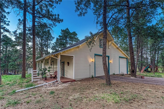 view of property exterior with a garage and a playground