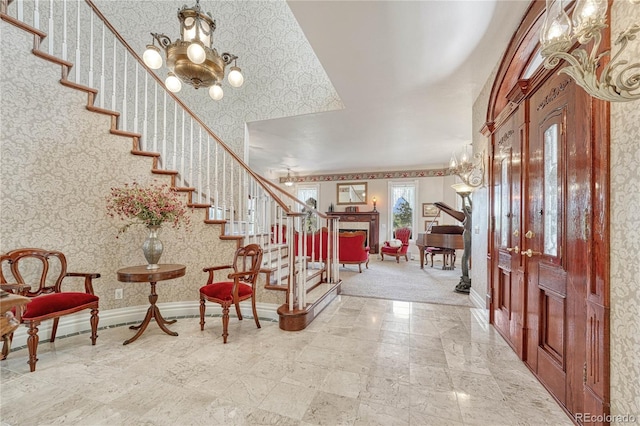 foyer entrance featuring an inviting chandelier