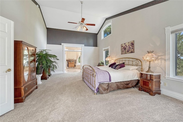 bedroom featuring multiple windows, ceiling fan, and light colored carpet