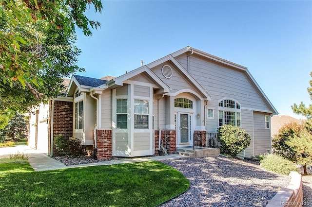 view of front of house with brick siding and a front yard