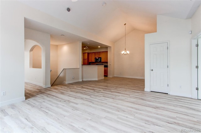 interior space with light wood-type flooring, baseboards, high vaulted ceiling, and a chandelier