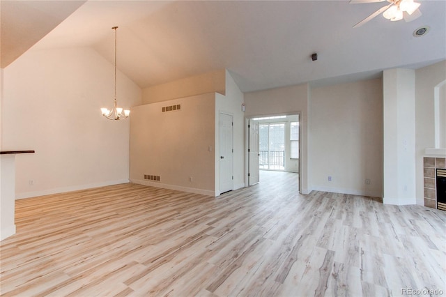 unfurnished living room featuring a tiled fireplace, ceiling fan with notable chandelier, light wood-style floors, and visible vents