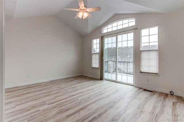 spare room with ceiling fan, visible vents, lofted ceiling, and wood finished floors