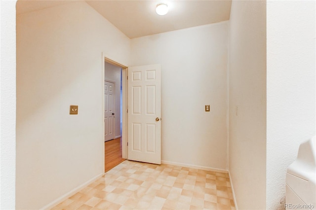 unfurnished room featuring light floors and baseboards