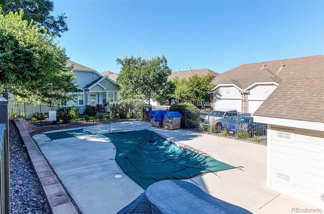 pool with a patio and fence