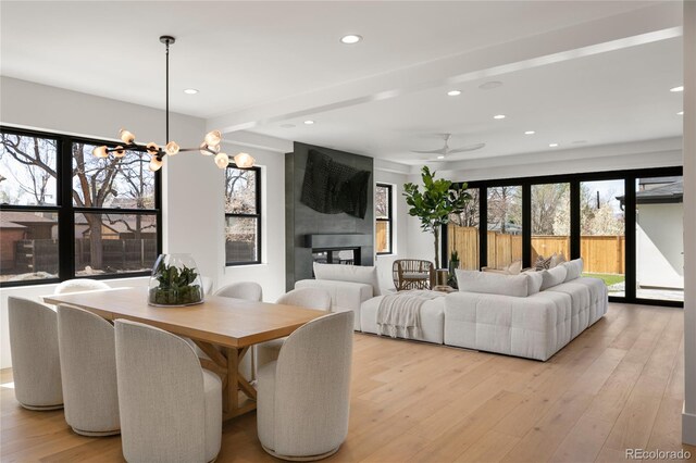 1195 S Milwaukee St, Denver, CO 80210 - dining room featuring recessed lighting, light wood finished floors, a ceiling fan, and a chandelier