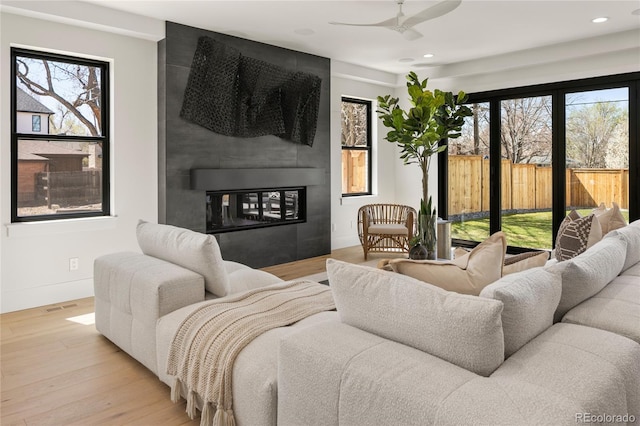 1195 S Milwaukee St, Denver, CO 80210 - living room featuring a fireplace, recessed lighting, wood finished floors, a ceiling fan, and baseboards