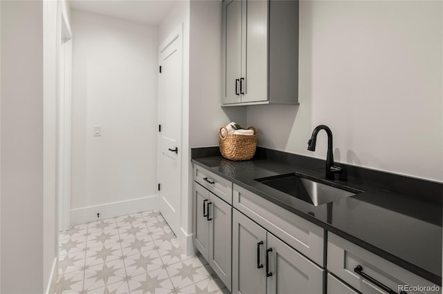 1195 S Milwaukee St, Denver, CO 80210 - washroom featuring a sink, light flooring, and baseboards