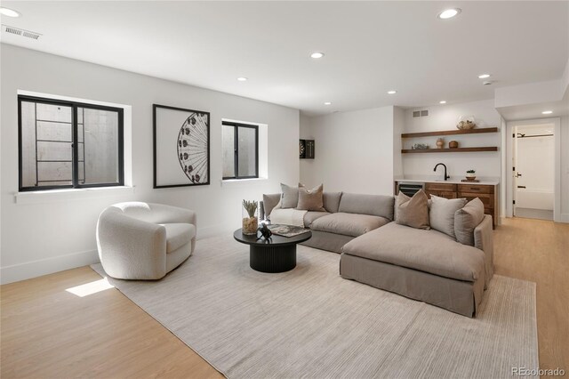 1195 S Milwaukee St, Denver, CO 80210 - living room featuring wet bar, light wood finished floors, recessed lighting, and baseboards